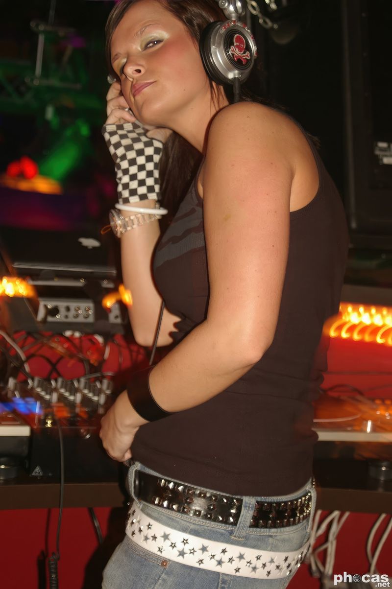 Kelly Trance in headphones at the DJ booth