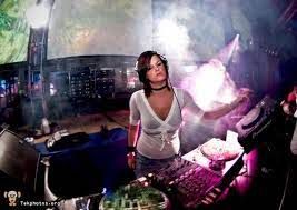Kelly at the decks in a smoky club